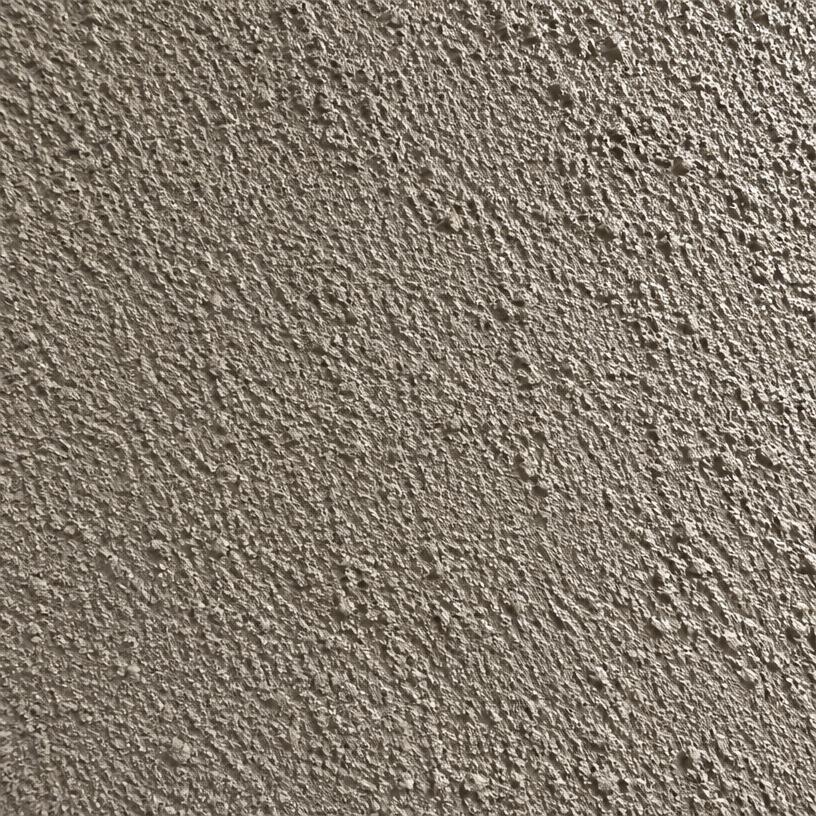 Close-up of coarse dash finish stucco in light taupe