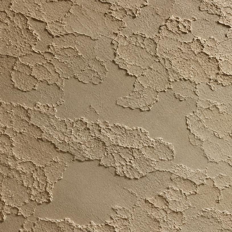 Close-up of lace skip-trowel stucco texture in warm beige